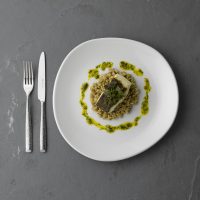 OVERHEAD- TRACE PLATE WITH RAKU CUTLERY. FISH AND RISOTTO